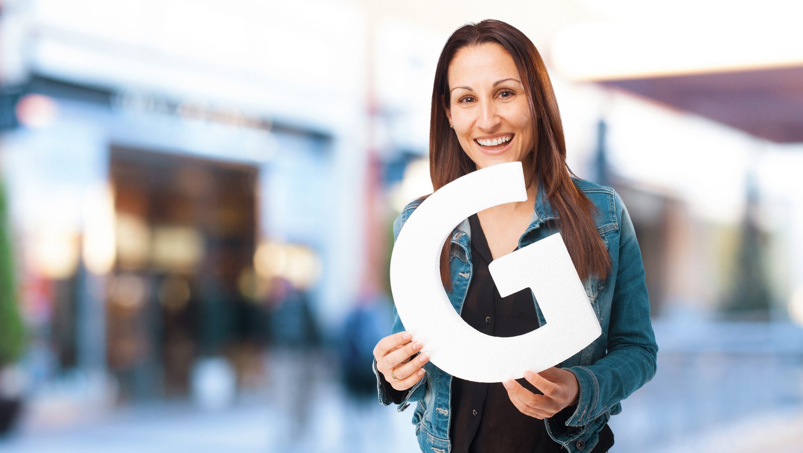 woman holding the G letter